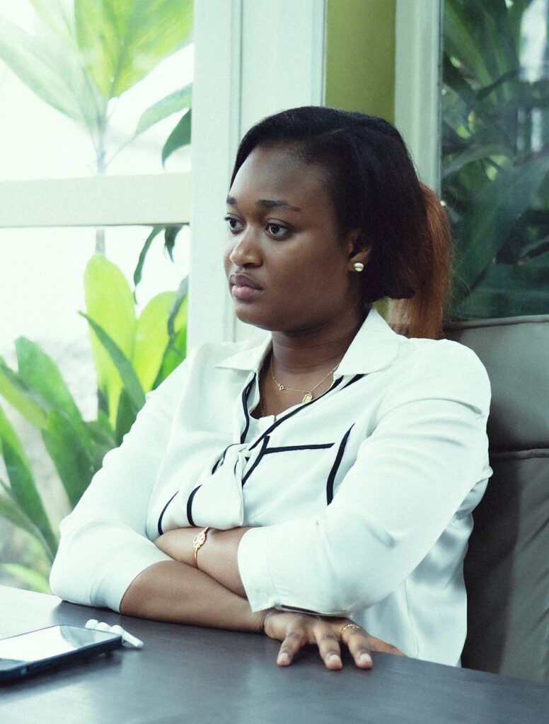 woman in a white shirt sitting at a desk